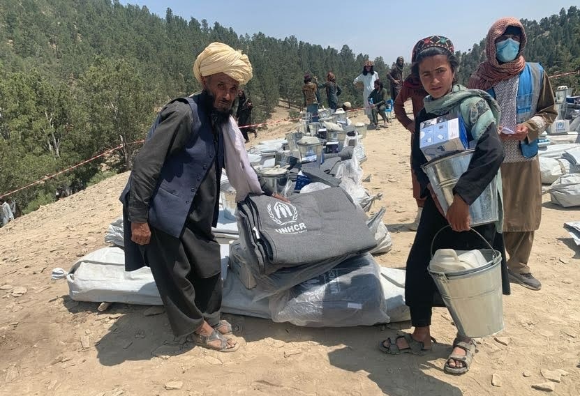 A family collects a relief items kit from the UNHCR distribution point in Khost Province following an earthquake.