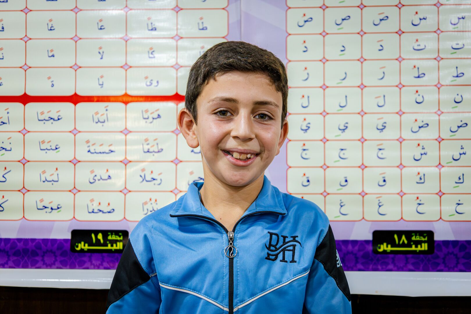 A refugee student takes part in a literacy program at Za’atari refugee camp in Jordan, supported by UNHCR.