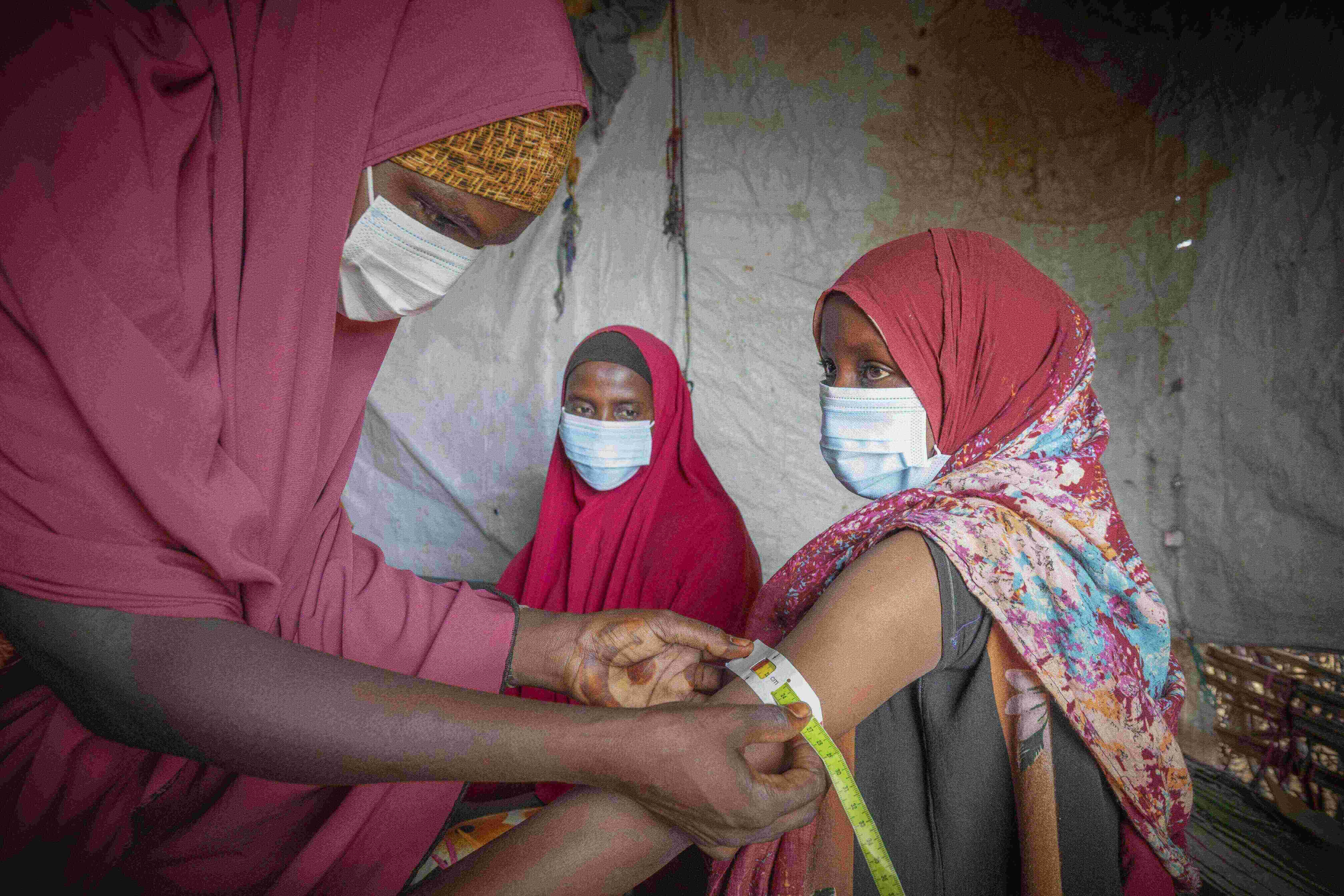 Ethiopia, Melkadida refugee camp, Dahabo Abdi Ahmed (red dress, dark blue black hair band), 34-year-old mother of seven, is one of the lead mothers of the nutrition programs funded by La Caixa in Melkadida refugee camp.