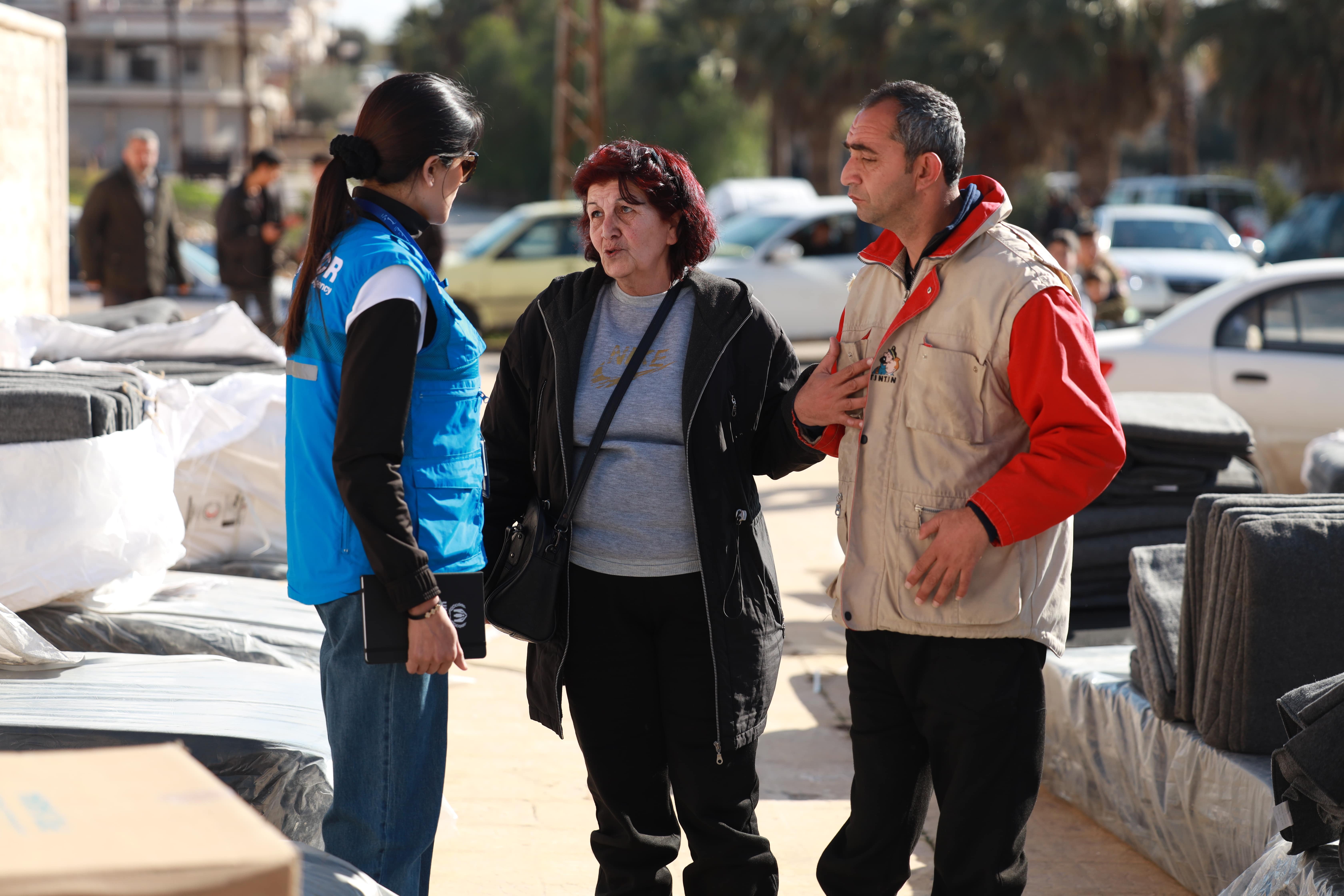 A UNHCR staff member meets Aziza and her son, who has special needs, who fled their home after the earthquakes struck south-eastern Türkiye and northern Syria on 6 February.