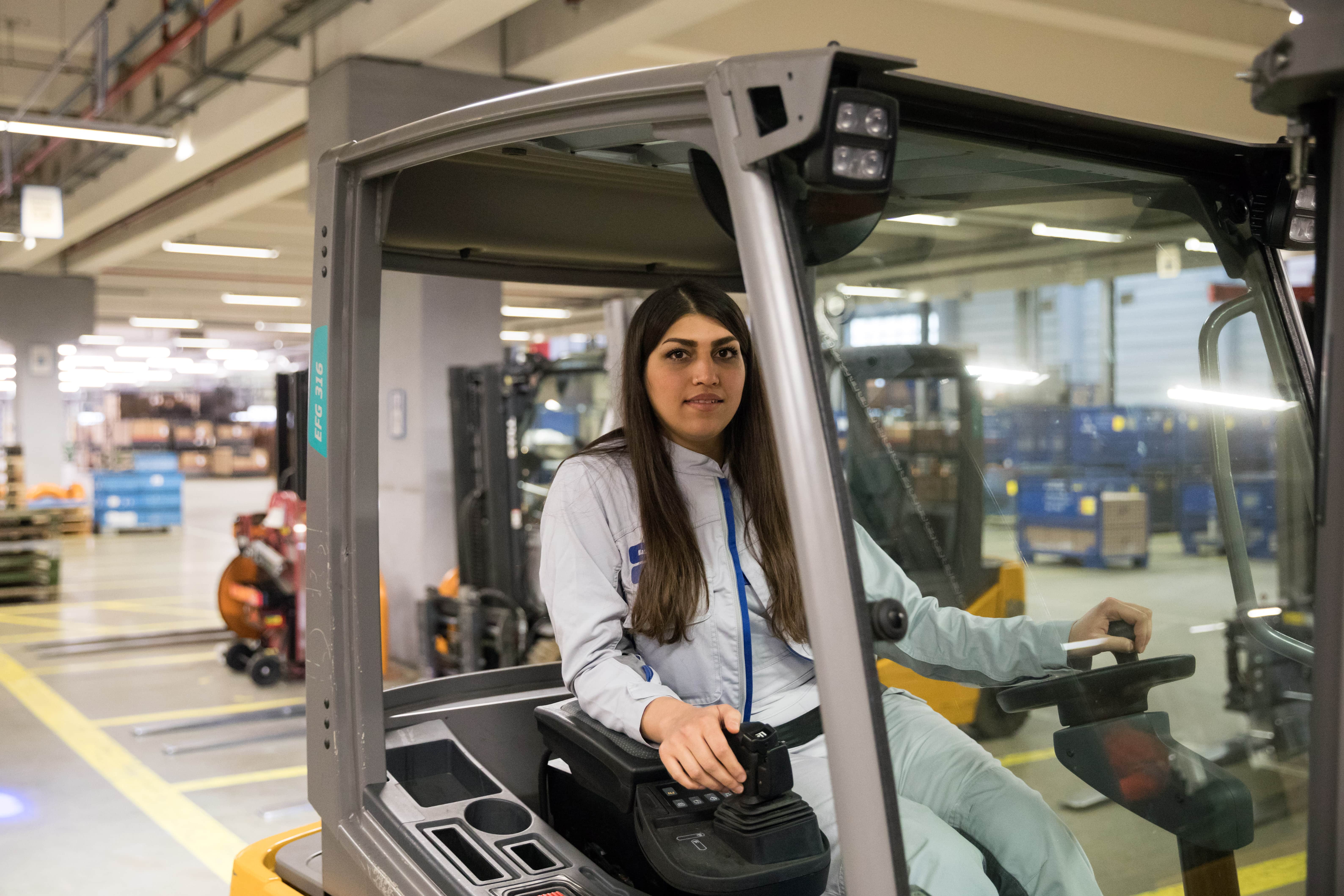 Mastura, an Afghan refugee, drives a forklift truck at the VW logistics centre in Baunatal, Germany.