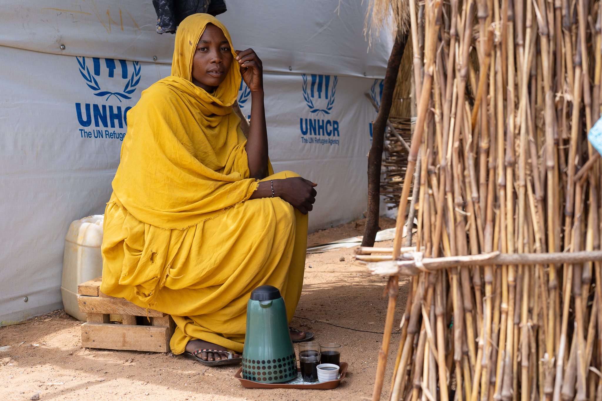 Zeinab prepares coffee in her new shelter in a refugee camp in Chad.