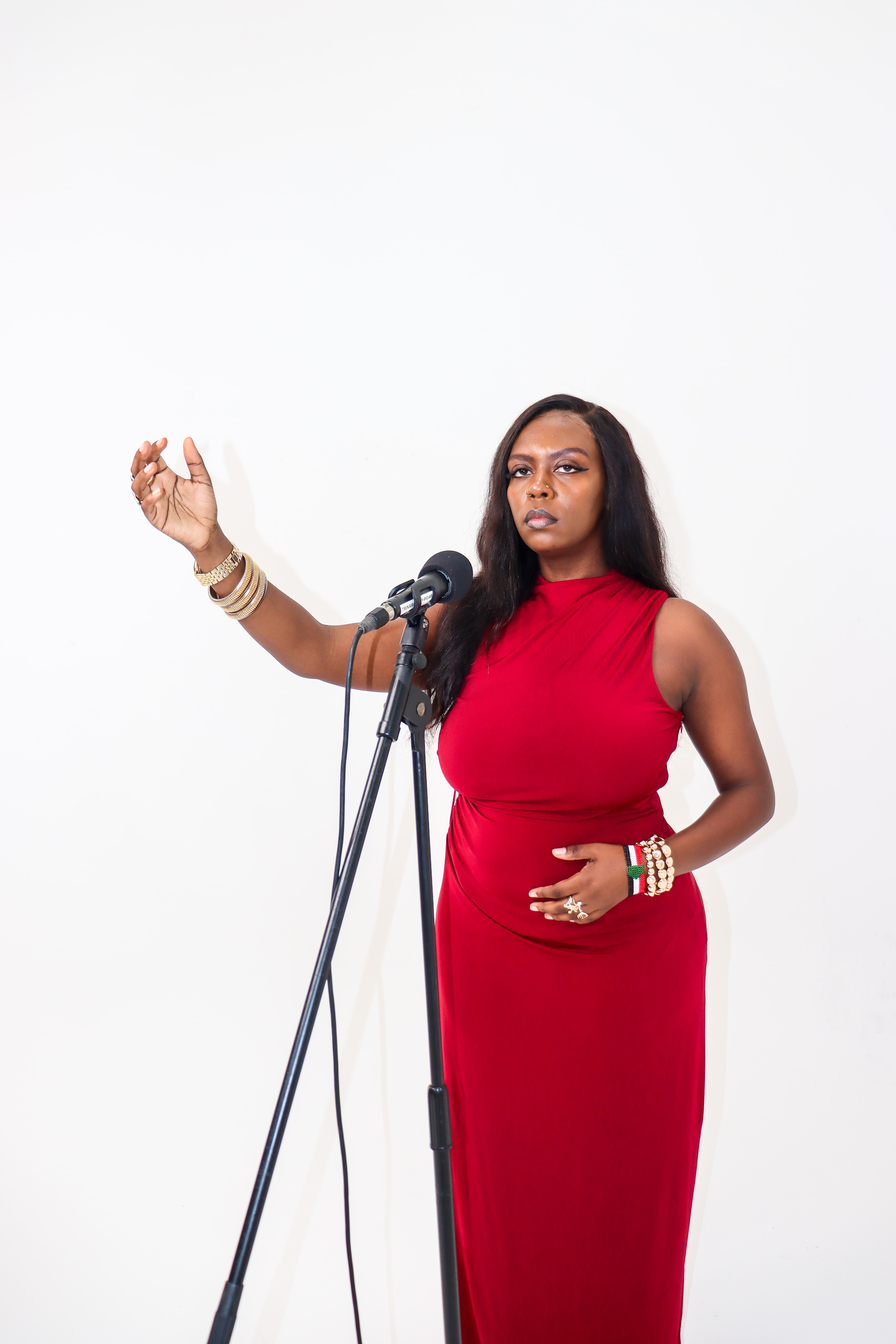Slam poet Huda the Goddess performs at a microphone. She is the winner of the 2025 Australia for UNHCR - SBS Les Murray Award for Refugee Recognition.
