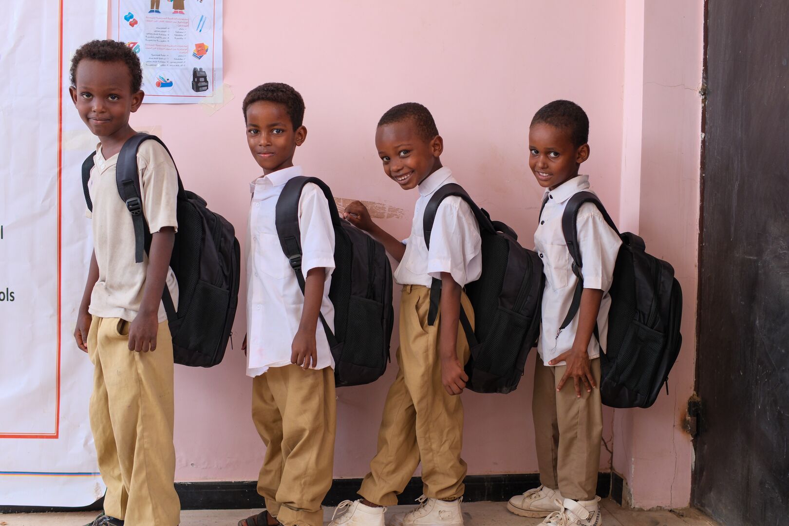 A group of Somali refugee school kits stand with their new back to school kits