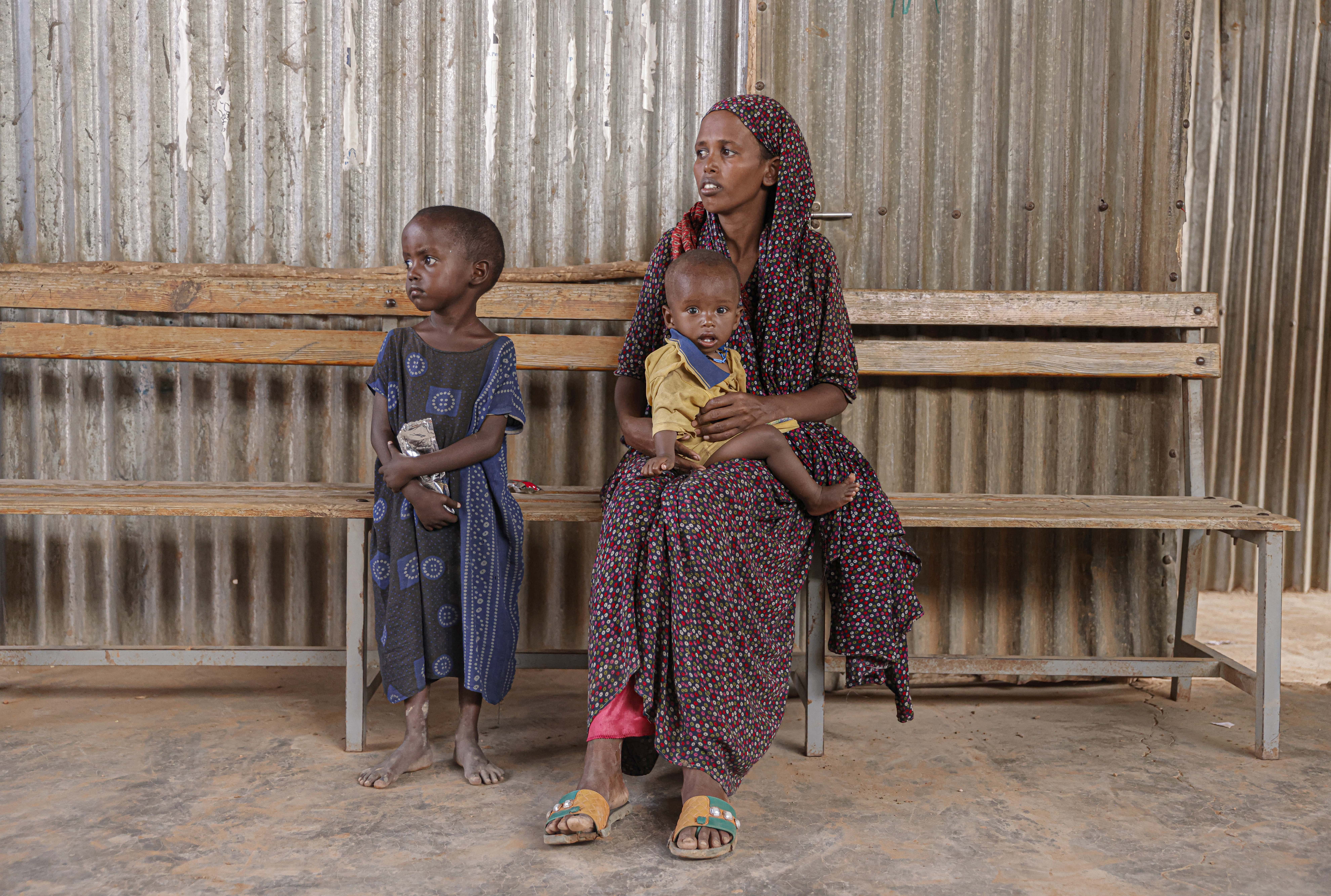 Samira Abdi, 28 waits to receive food and treatment for her malnourished children at the Melkadida UNHCR supported food distribution centre in Melkadida