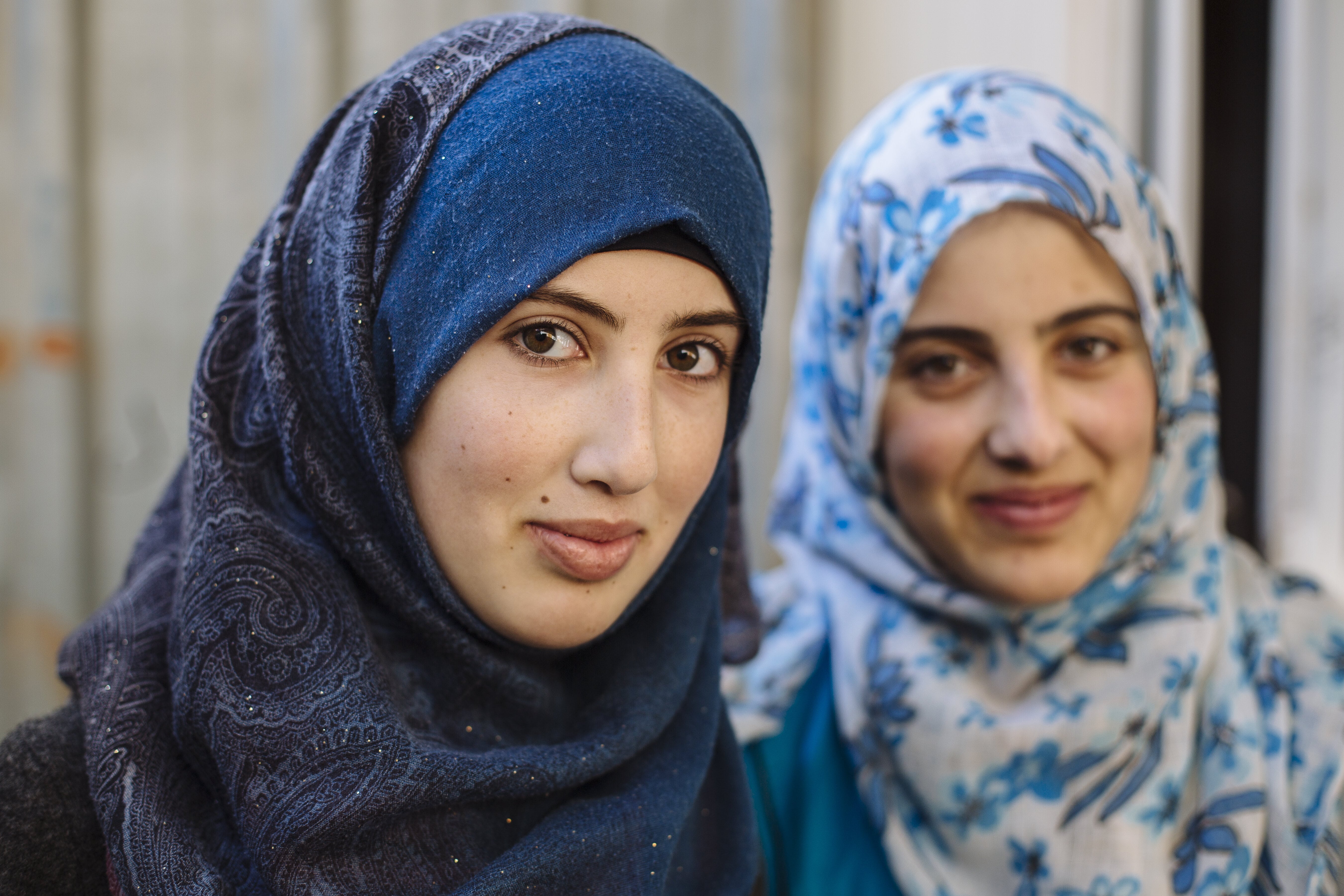 Two Syrian refugee sisters in the family's shelter in Zaatari refugee camp in Jordan