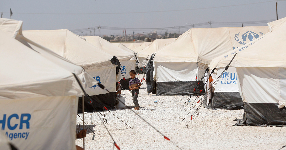 A Syrian refugee child walks near the tents in Al Zaatari camp for Syrian refugees, near the border with Syria. @UNHCR/ Salah Malkawi