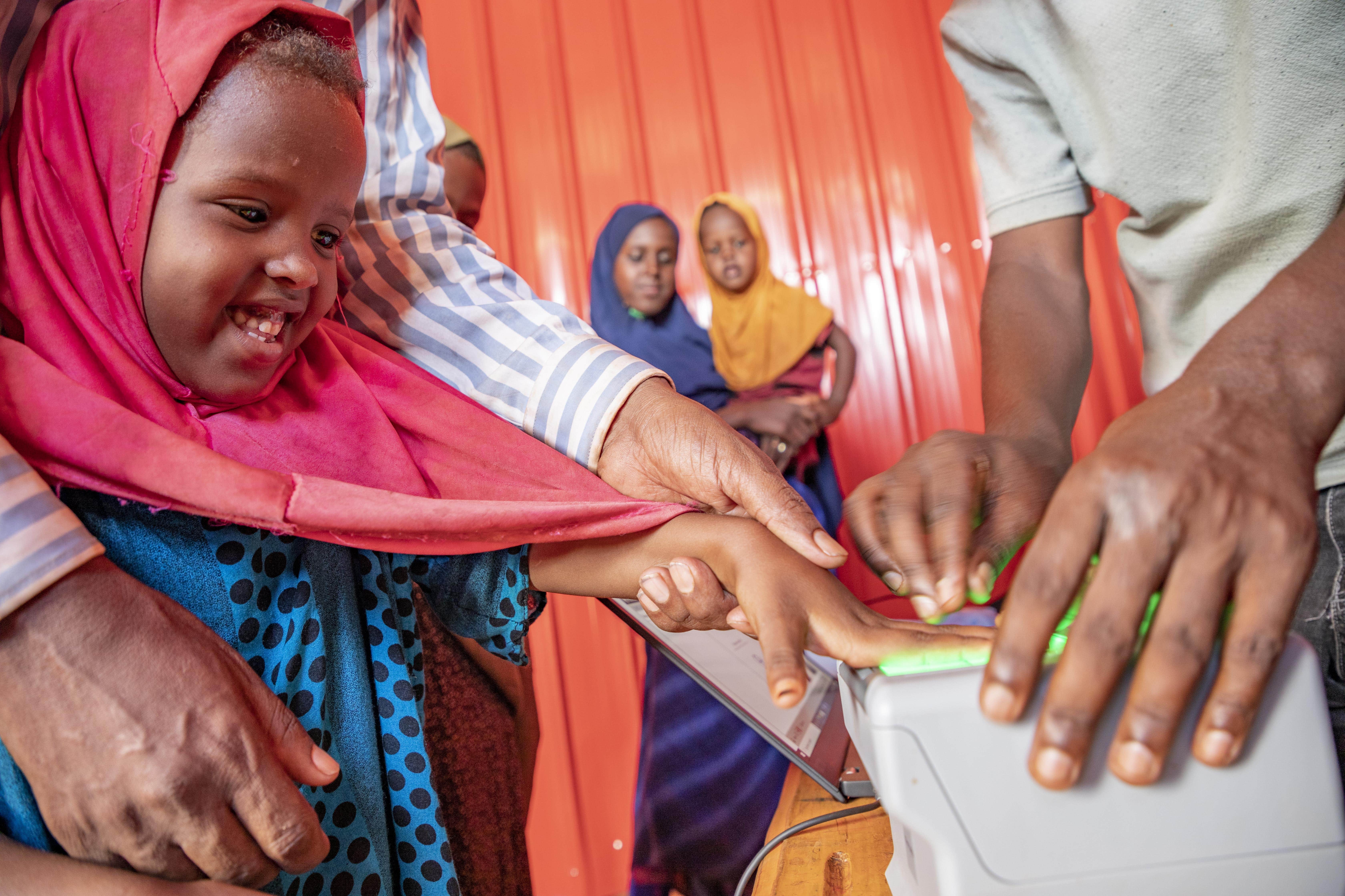 Young Naima Mohamed, 5, gets her prints taken during biometric registration. 
