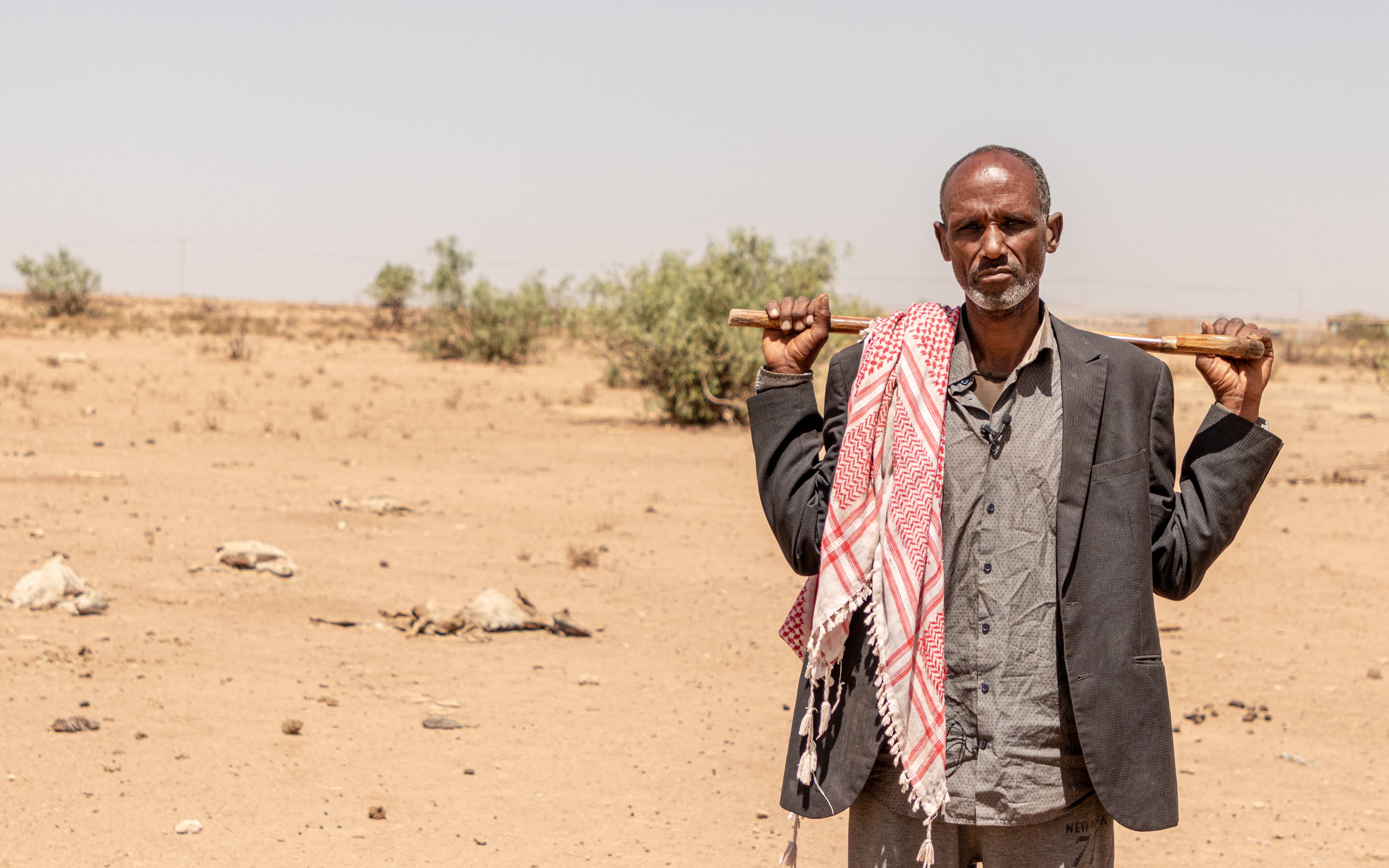 Displaced person, Abdullahi stands facing camera. He was forced to leave his wife and seven children behind in their village. 